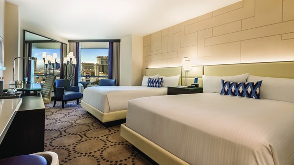 Hotel room with two beds and a large window