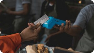 Calling Abroad from the UK: How Lebara International Minutes Work Hands holding a smartphone and a bank card at a cafe table