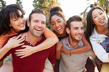 Group of smiling friends together outdoors