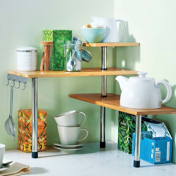 Wooden corner shelf unit holding kitchenware