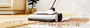 Gtech AirRAM 3 cordless upright vacuum cleaning crumbs from a wooden floor