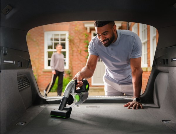 Man cleaning a car boot with the Gtech Multi cordless handheld vacuum