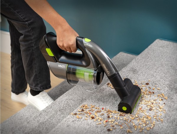 Person cleaning stairs with the Gtech Multi cordless handheld vacuum