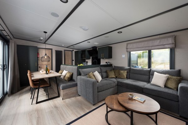 The open-plan living and dining area of a Shadow Wood holiday home