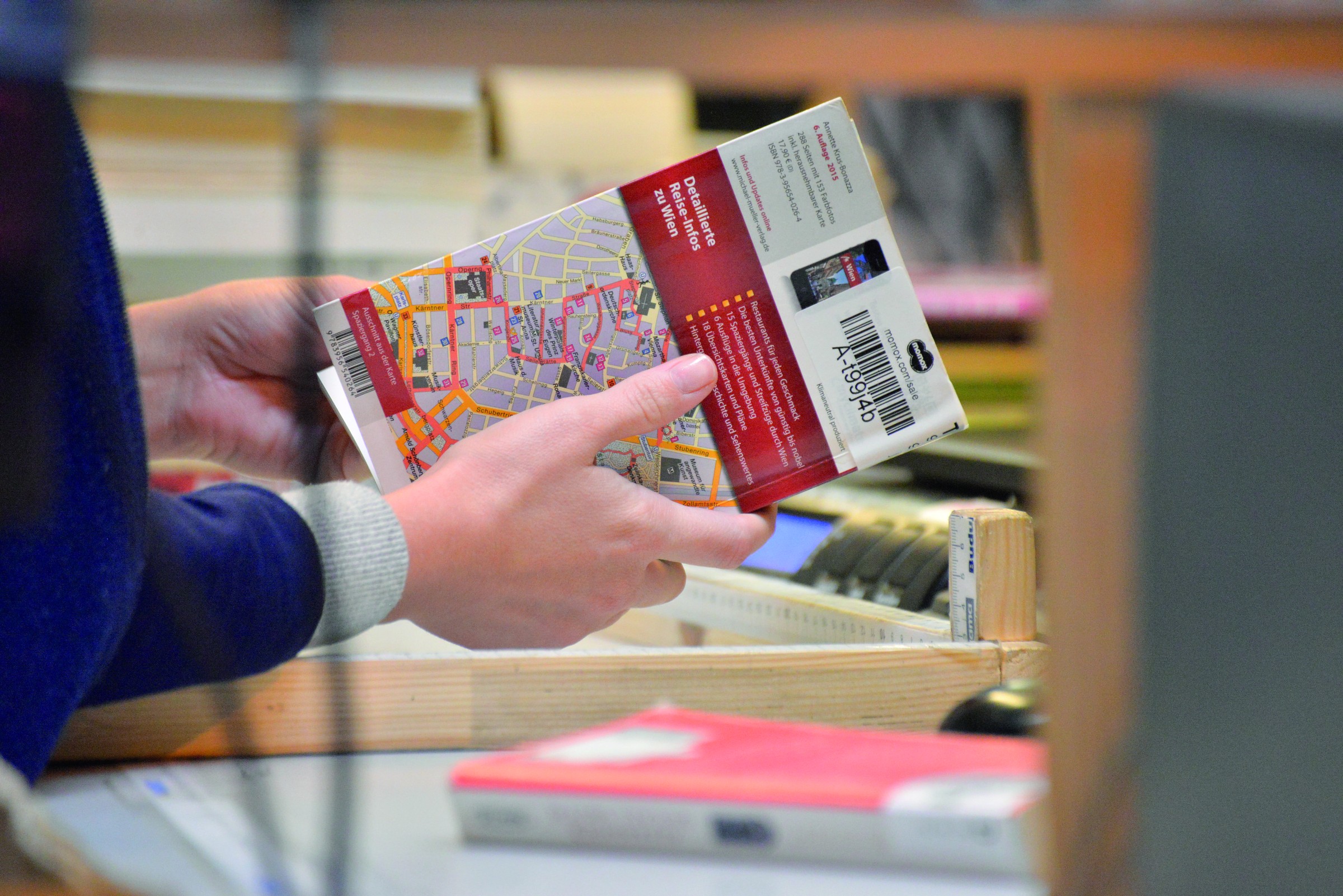 A worker checking the condition of a second-hand book before it is sold