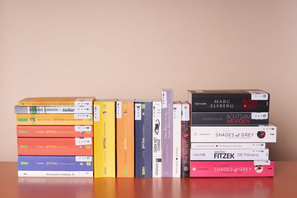 A colourful row of second-hand paperback bestsellers standing on a shelf