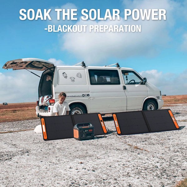 Jackery SolarSaga panels charging power stations next to a campervan