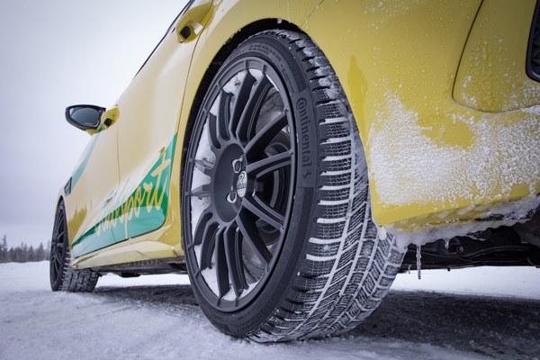 Yellow car on a snowy road fitted with Continental winter tyres