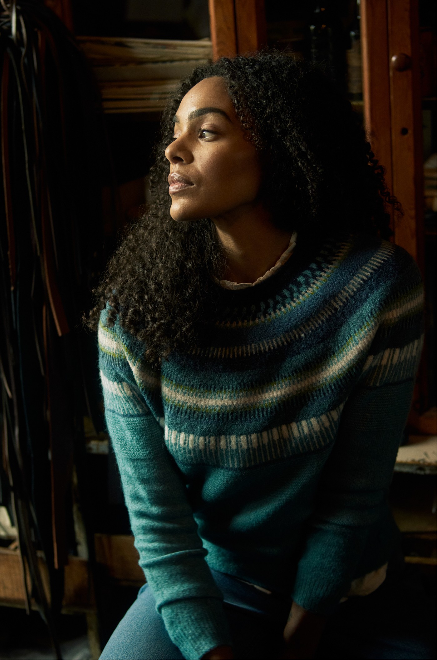 Woman wearing a teal patterned knitted jumper