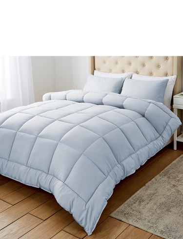 Chums All in One duvet in a pastel blue shade on a made bed